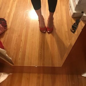 Red/orange Aldo sandals with a small heel